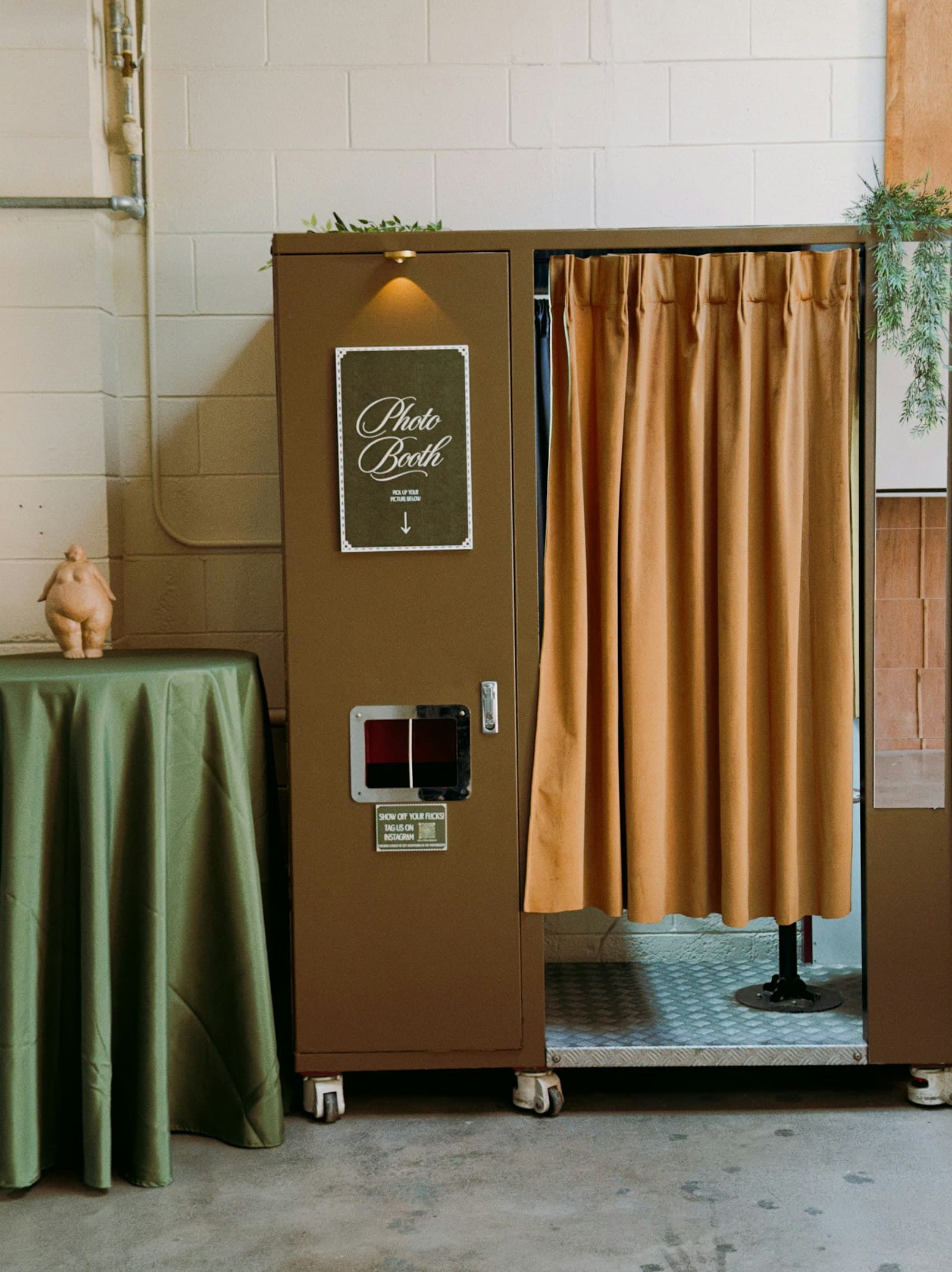 Vintage photo booth with a draped curtain backdrop