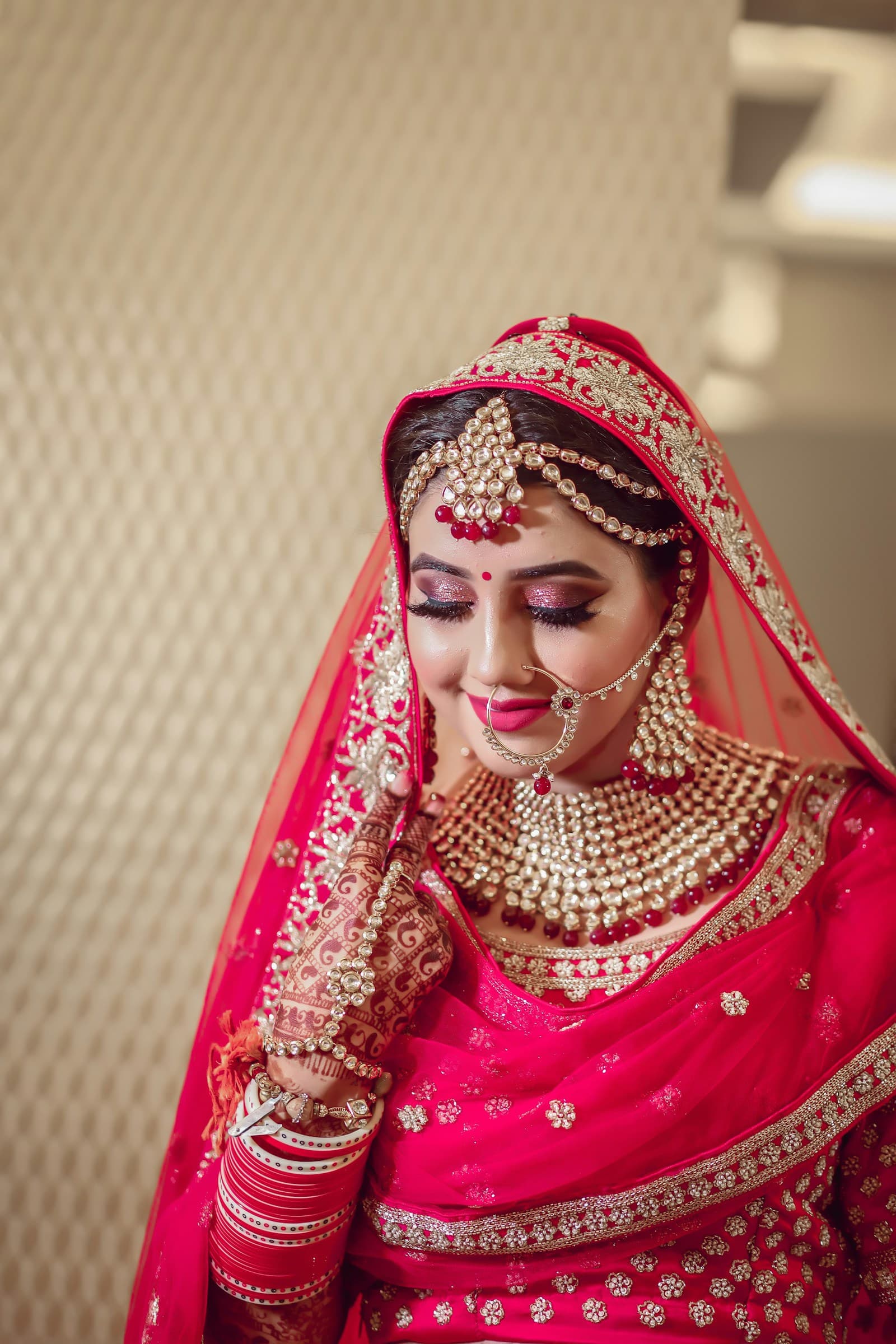 South Asian bride having makeup applied
